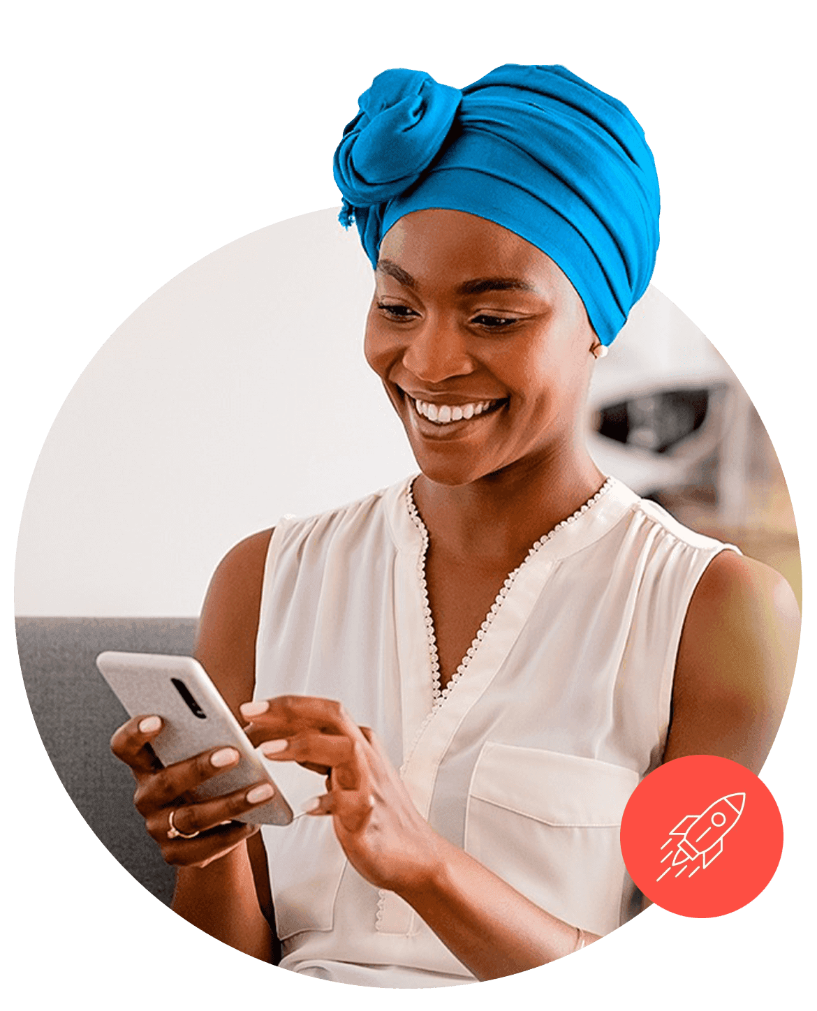 A woman smiling at a message on her phone